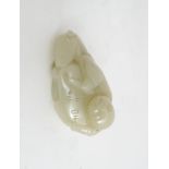 A CHINESE JADE FIGURE CARVING the recumbent figure holding a scroll, with a toad, 6cm wide and 3cm