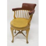 A CAPTAINS BEECH REVOLVING SHIPS ARMCHAIR CHAIR with brown vinyl upholstered comb back on