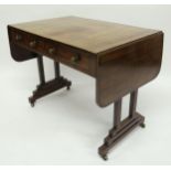 A VICTORIAN MAHOGANY SOFA TABLE with square supports terminating in staggered geometric scroll feet,