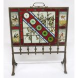 A VICTORIAN BRASS AND STAINED GLASS FIRE SCREEN with four hand painted inset panels depicting