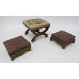 A VICTORIAN WALNUT FRAMED TAPESTRY UPHOLSTERED FOOTSTOOL on two X-frame supports joined by turned