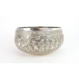 AN INDIAN WHITE METAL BOWL decorated with a procession of military figures and elephants, beneath