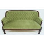 A VICTORIAN ROSEWOOD FRAMED BUTTONBACK PARLOUR SETTEE with green upholstery on turned supports, 85cm