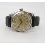 A ROLEX OYSTER PERPETUAL in stainless steel with aged dial, with luminous Arabic and dot numerals.