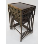A 19TH CENTURY CHINESE FAUX BAMBOO HARDWOOD NEST OF FOUR TABLES with carved foliate fretwork