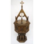 A PUGINESQUE OAK OCTAGONAL BAPTISMAL FONT with architectural style oak font cover concealing stone