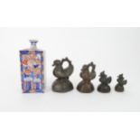FOUR BURMESE BRONZE OPIUM WEIGHTS cast as ducks, 6 to 10cm high and an Imari square bottle vase,