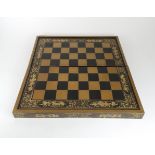 A CHINESE BLACK AND GOLD LAQUERED GAMES BOX the exterior for chequers the interior backgammon and