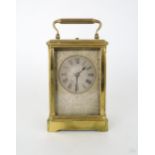 A FRENCH BRASS REPEATER CARRIAGE CLOCK with silvered chased dial and roman numerals, the movement