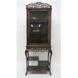 A 19TH CENTURY CHINESE HARDWOOD GLAZED DISPLAY CABINET ON STAND with carved fretwork cornice and