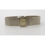 A 9CT WHITE GOLD LADIES ROLEX PRECISION with oblong case and integral woven strap. Dimensions of the