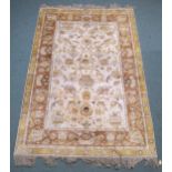 A CREAM GROUND SAVONNERIE RUG with all over design and yellow borders, 190cm long x 130cm wide