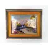 A LIMOGES ENAMEL PANEL of rectangular convex form, painted with a riverscape beside a mountain and