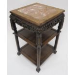 A 19TH CENTURY CHINESE HARDWOOD THREE TIER PEDESTAL TABLE with pink marble top, carved foliate
