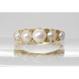 A VICTORIAN PEARL & DIAMOND RING set with five half pearls the largest diameter 5.5mm, with the