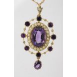 A 15CT GOLD EDWARDIAN PENDANT set with amethyst and pearls, the central amethyst is approx 13.5mm