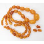 A STRING OF AMBER COLOURED BEADS largest bead 22.7mm, smallest 9.1mm, weight 33.4gms Condition