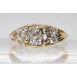 AN ART NOUVEAU THREE STONE DIAMOND RING the bright yellow metal mount with chased foliate