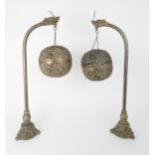 A PAIR OF CHINESE BRASS LANTERNS each with dragon stems, holding a brocade ball and on a dragon cast