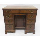 A GEORGIAN MAHOGANY AND WALNUT VENEERED KNEEHOLE DESK with one long drawer above two banks of