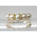 A BRIGHT YELLOW METAL PEARL RING the five half pearls are in cut back settings with reeded