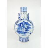 A CHINESE BLUE AND WHITE PILGRIM VASE painted with panels of figures crossing bridges into river