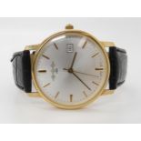 A 9CT GOLD WHW QUARTZ WRISTWATCH with brushed silvered dial, gold baton numerals and a date