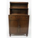 A19TH CENTURY MAHOGANY CABINET with two open book shelves above two drawers above two panel doors on