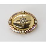 A YELLOW METAL PEARL SET STAR BROOCH  with a locket back. Dimensions 4.3cm x 3.3cm, weight 19.2gms