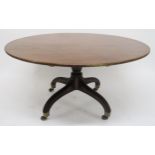 A GEORGIAN MAHOGANY CIRCULAR TILT TOP BREAKFAST TABLE on quadrupedal pedestal base with spade feet