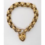 A BRIGHT YELLOW METAL SNAKE BRACELET the chain is a large open link with a heart shaped locket clasp