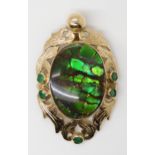 A YELLOW METAL AMMOLITE AND EMERALD PENDANT signed by goldsmith C. Noir, inscribed 14k. Set with