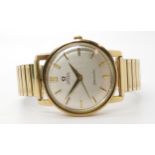 A 9CT GOLD GENTS OMEGA SEAMASTER AUTOMATIC with silvered dial with gold coloured baton numerals,