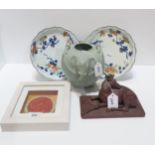 A Elephant head celadon glazed pot, a model of a stag, two Chines plates and a framed plaque