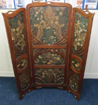 A Victorian mahogany framed screen surrounding overpainted embossed leather panels 166cm high