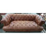 A Contemporary tan leather upholstered button back chesterfield club style sofa on turned feet, 68cm