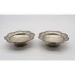 A pair of silver comports / pedestal dishes, the edges scalloped, by Mappin & Webb,  Sheffield 1939,