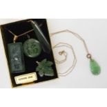 A carved Chinese green hardstone pendant with yellow metal bail and chain, together with a New