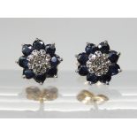 A pair of 9ct yellow and white gold sapphire and diamond flower earrings, weight 1.9gms Condition