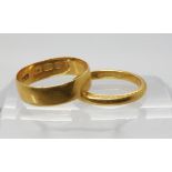 A 22ct gold wedding ring, size K1/2, together with a further example size O1/2, weight together 6.