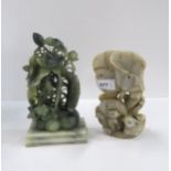 A Chinese white hardstone model of lotus flowers and ducks together with a green hardstone group