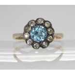 An 18ct gold blue zircon and diamond cluster ring, size O1/2, inscribed to inner shank and dated