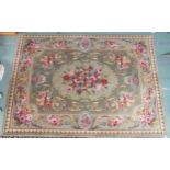A green ground Aubusson style floral pattern rug, 241cm long x 169cm wide and another contemporary