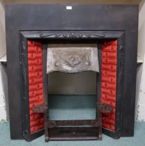 A Victorian Arts & Crafts cast iron fire insert with red tiled sides over cast iron grill, 107cm