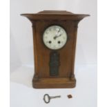 A wooden mantle clock with inlaid metal plaque Condition Report:Available upon request