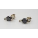 A pair of white metal black and white diamond earrings, the black diamond is estimated approx at 0.
