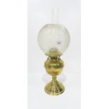 An oil lamp with brass base and etched shade Condition Report:Available upon request