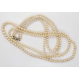 A double string of pearls with a 9ct white gold diamond set clasp, length of shortest length 42cm,