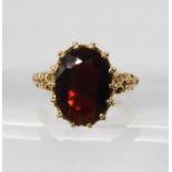 A 9ct gold garnet dress ring with decorative mount, hallmarked London 1977, finger size O, weight