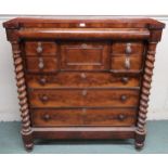 A Victorian mahogany Scotch chest of drawers with barley twist columns flanking central bank of